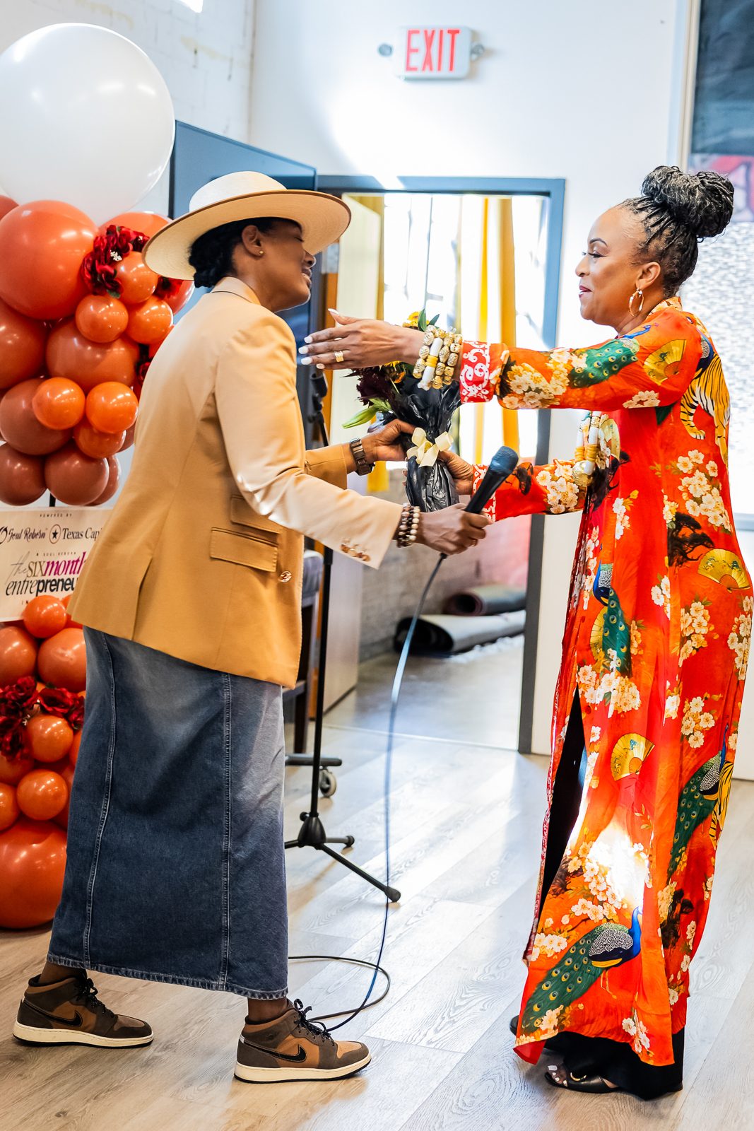 Two women embracing at the graduation celebration