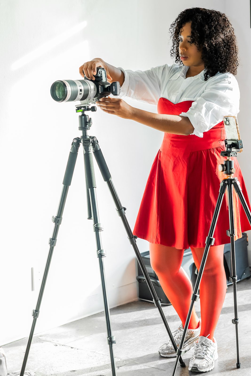 A photographer setting up a camera for professional headshots